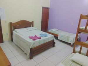 a bedroom with two beds with flowers on them at Pousada do Joca Bonito/MS in Bonito +114 photos