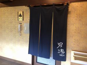 a curtain is hanging on a wall in a room at Dormy Inn Premium Kyoto Ekimae Natural Hot Spring in Kyoto