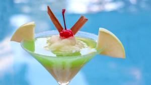 a green drink with a cherry on top of it at Holiday Inn San Luis Potosi-Quijote, an IHG Hotel in San Luis Potosí