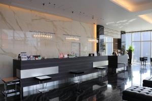 a lobby with a counter with stools and a bar at Piazza Hotel Nara in Nara