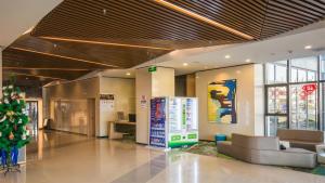 a lobby with a christmas tree in a building at Holiday Inn Express Zhangjiakou Park View, an IHG Hotel in Zhangjiakou