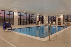 a large swimming pool in a hotel building at Staybridge Suites - Overland Park - Kansas City S, an IHG Hotel in Overland Park