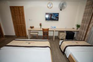 Postel nebo postele na pokoji v ubytování Huynh Duc 2 Hotel