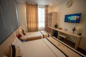 Postel nebo postele na pokoji v ubytování Huynh Duc 2 Hotel