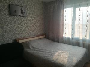 A bed or beds in a room at Like Home Apartmants 32 микрорайон 5 д
