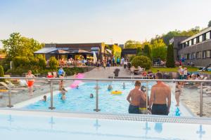a group of people in an outdoor swimming pool at Bø Hotel in Bø