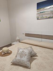 a bedroom with a bed with a hat and a pillow at Apartment Stella Maris in Cala Gonone