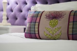 a pillow with a pineapple painted on it sitting on a bed at Beachlands Hotel in Weston-super-Mare