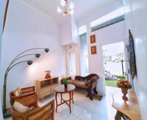a living room with a couch and a table at Rumah Sorai in Batu