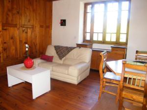 a living room with a couch and a table at Domaine Sela in Saint-Prix