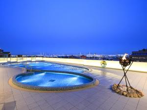 a swimming pool on the roof of a building at APA Hotel & Resort Yokohama Bay Tower in Yokohama