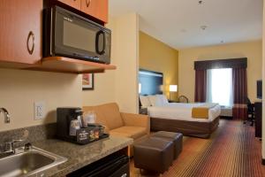 a hotel room with a bed and a bathroom at Holiday Inn Express Hotel & Suites Prattville South, an IHG Hotel in Prattville