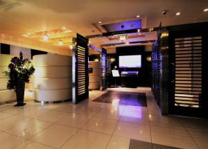 a lobby of a building with a tv in it at Hotel Opus -Adult only- in Kasugai