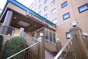 a hotel with a sign on the front of a building at Richmond Hotel Tokyo Musashino in Musashino