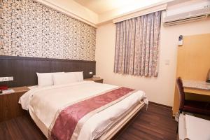 Postel nebo postele na pokoji v ubytování King Town Hotel