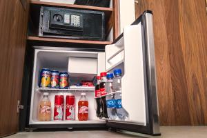 an open refrigerator with soda and drinks in it at Hotel Boutique Parque Centro in Mexico City