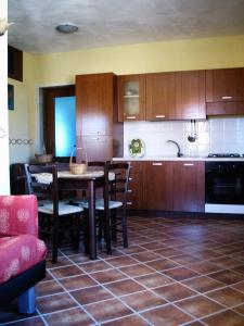 a kitchen with a table and chairs and a kitchen with at Il Ritrovo degli Angeli in San Mauro Cilento