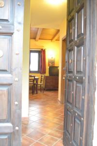 a hallway with a door and a living room at Il Ritrovo degli Angeli in San Mauro Cilento