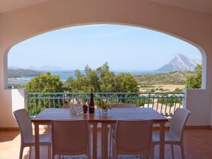 a table and chairs on a balcony with a view at Residence Hotel Lu Nibareddu in San Teodoro