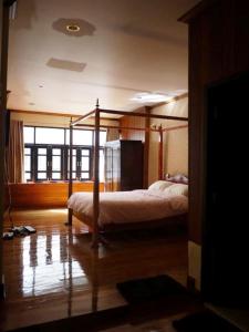 a bedroom with a canopy bed in a room at The Royal ThaTien Village in Bangkok