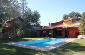 a swimming pool in the yard of a house at Xalet De Prades in Prades