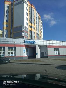 a building with a sign on top of it at Apartment on Zhaloytskaga 35 in Pinsk