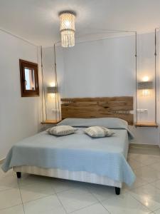 a bedroom with a bed with two pillows on it at Villa Christine in Agia Anna Naxos