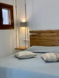 two pillows on a bed in a bedroom at Villa Christine in Agia Anna Naxos