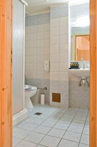 a bathroom with a sink and a toilet at Casa Del Mar in Chania Town