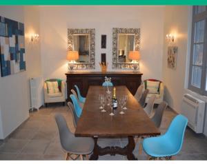 a dining room with a table and chairs and mirrors at Le Petit Chateau in Puilaurens