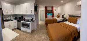 a hotel room with two beds and a kitchen at Captiva Beach Resort (open private beach access) in Sarasota