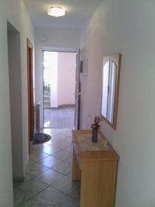 a room with a hallway with a counter and a mirror at Apartments Buljevic in Vrboska
