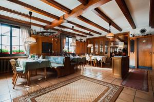 a restaurant with tables and chairs in a room at Landgasthaus Pfahl in Wershofen