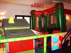 a room with a play room with a playground at Orfeas Land in Kormísta