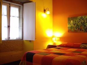 A bed or beds in a room at Pazo de Verdes