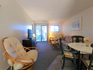 a living room with a couch and a table and chairs at Wessex Inn By The Sea in Cowichan Bay