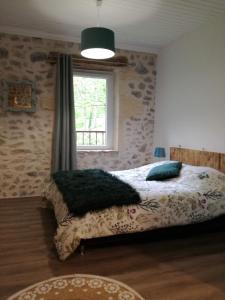 a bedroom with a bed and a window at L'Echevine en vercors in Échevis