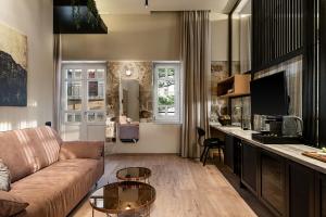 a living room with a couch and a table at Divino Suites Chania in Chania