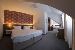 Voodi või voodid majutusasutuse Hotel Prichovice toas