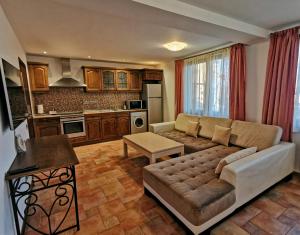a living room with a couch and a kitchen at Къща Наковски in Gabrovo