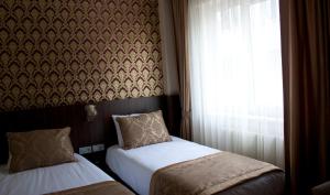 a bedroom with two beds and a window at Istanbul Central Hotel in Istanbul