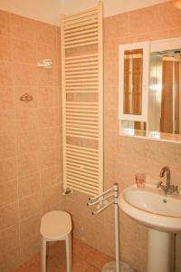 a bathroom with a sink and a toilet and a mirror at Turchese in Pomonte