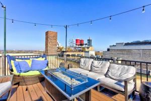 a patio with a couch and a table on a balcony at Vogue loft walk to CityMu/Cards/Aquarium/ConvCtr in Saint Louis