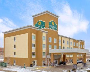 a large building with a sign on top of it at La Quinta by Wyndham Dickinson in Dickinson