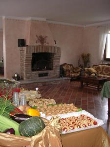 a living room with a table of food and a fireplace at Agriturismo Cascina Gilli in Spino dʼAdda