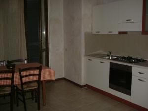a kitchen with a table and a sink and a stove at Agriturismo Cascina Gilli in Spino dʼAdda