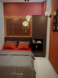 a bedroom with a bed with a red wall at 54 Homestay in Can Tho