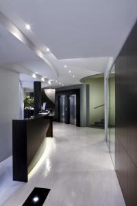 a hallway with a reception desk in a building at Twentyone Hotel in Rome