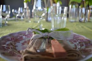 a plate with a napkin and a bow on a table at La Locanda di Valbella in Asti
