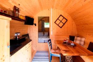 a log cabin with a dining table and a kitchen at Fasslhütte in Murau +29 photos